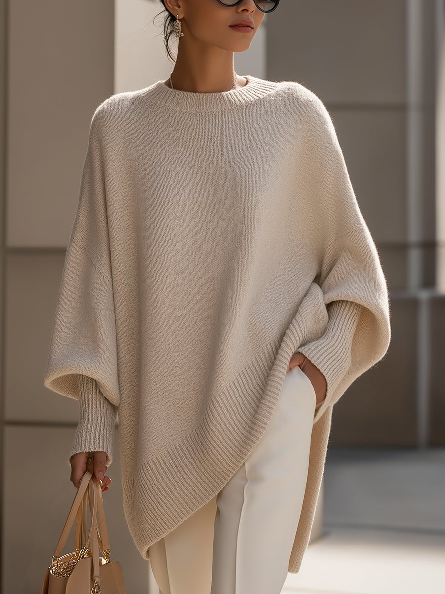 Woman wearing the Faith elegant sweater in beige, styled with tailored trousers for a polished everyday look