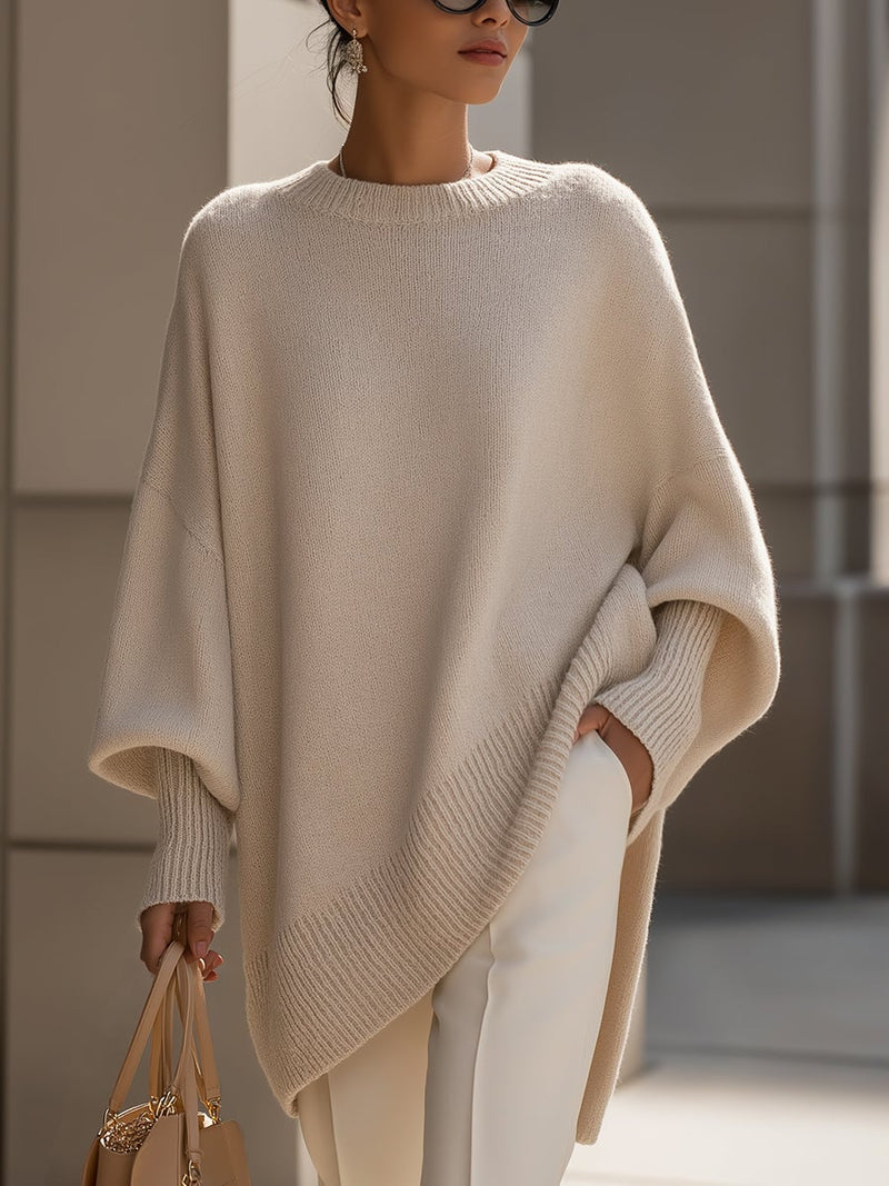 Woman wearing the Faith elegant sweater in beige, styled with tailored trousers for a polished everyday look