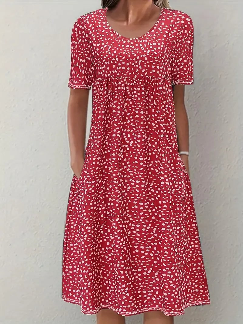 Woman wearing the Faith flowy elegant evening dress in red, showing the flattering waist-fitted silhouette and graceful neckline