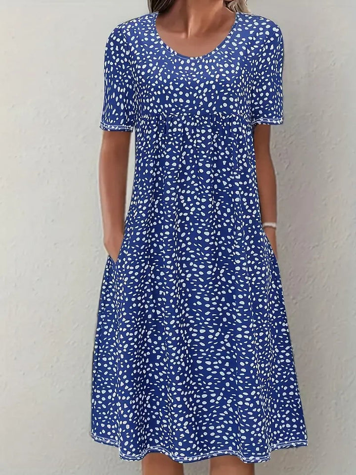 Side profile of the Faith flowy dress in blue, showcasing the smooth hip-skimming silhouette and lightweight fabric movement