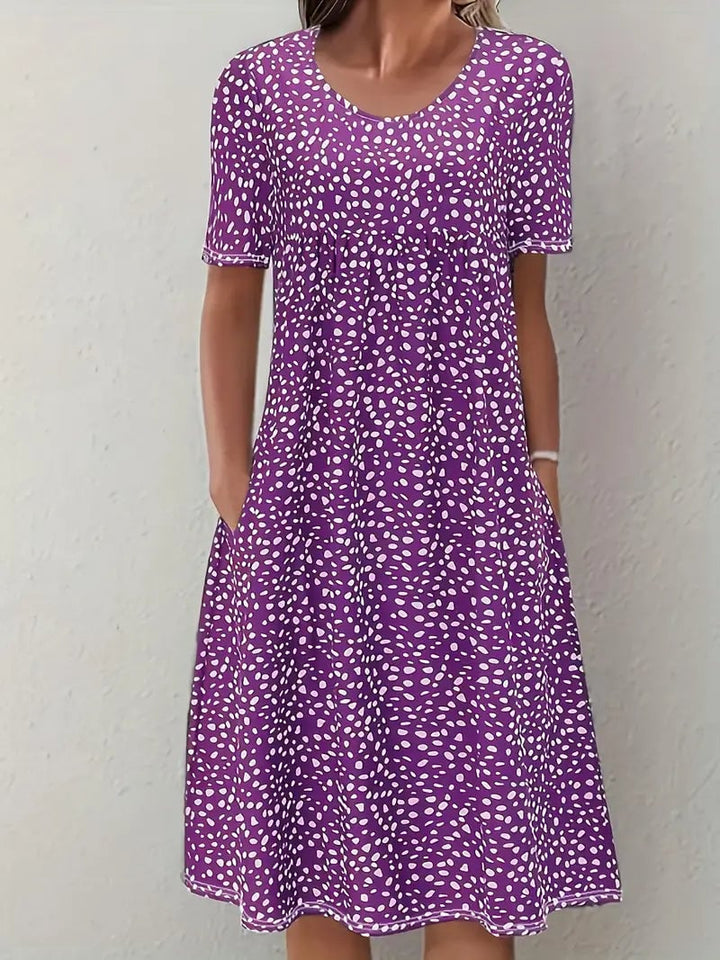 Close-up of the delicate neckline and refined seam finish on the Faith elegant evening dress in purple