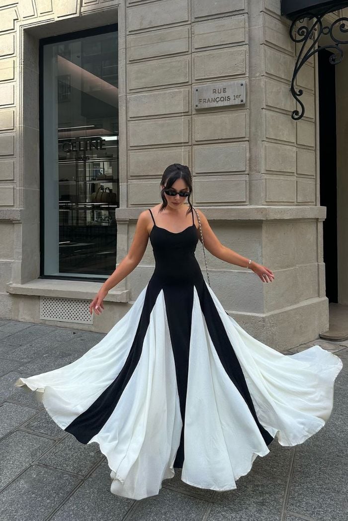 Model smiling in the Faye black and white lace maxi dress, styled for a wedding