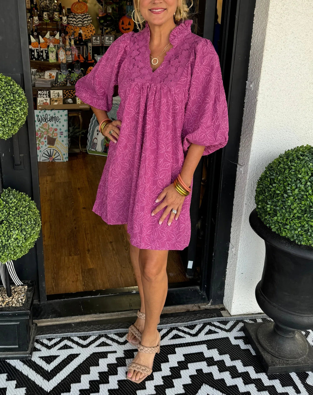 Woman wearing the Faye magenta jacquard babydoll mini dress with puff sleeves and ruffled V-neckline, front view