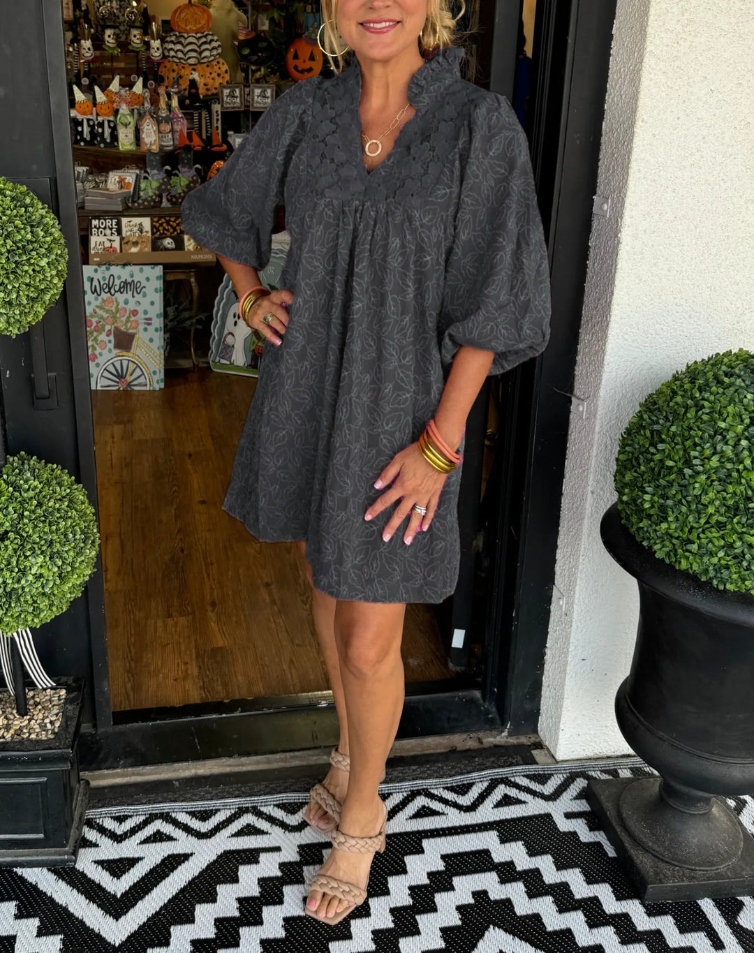 Side profile of the Faye mini dress highlighting the voluminous three-quarter puff sleeves and relaxed fit