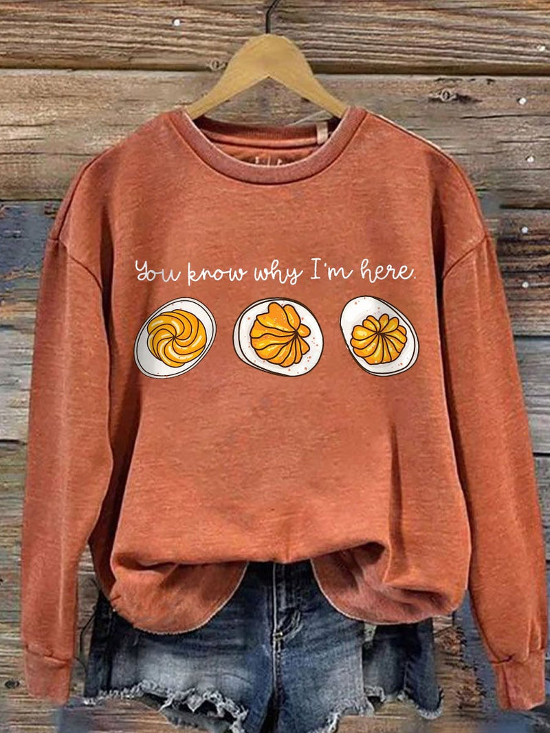 Model wearing a Pumpkin Orange Feast Mode graphic sweatshirt in a relaxed fit, styled for fall