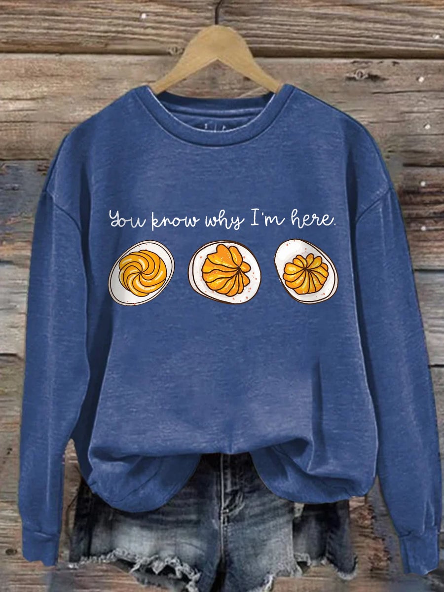 Close-up detail of the Feast Mode graphic on a soft fall sweatshirt in Pumpkin Orange