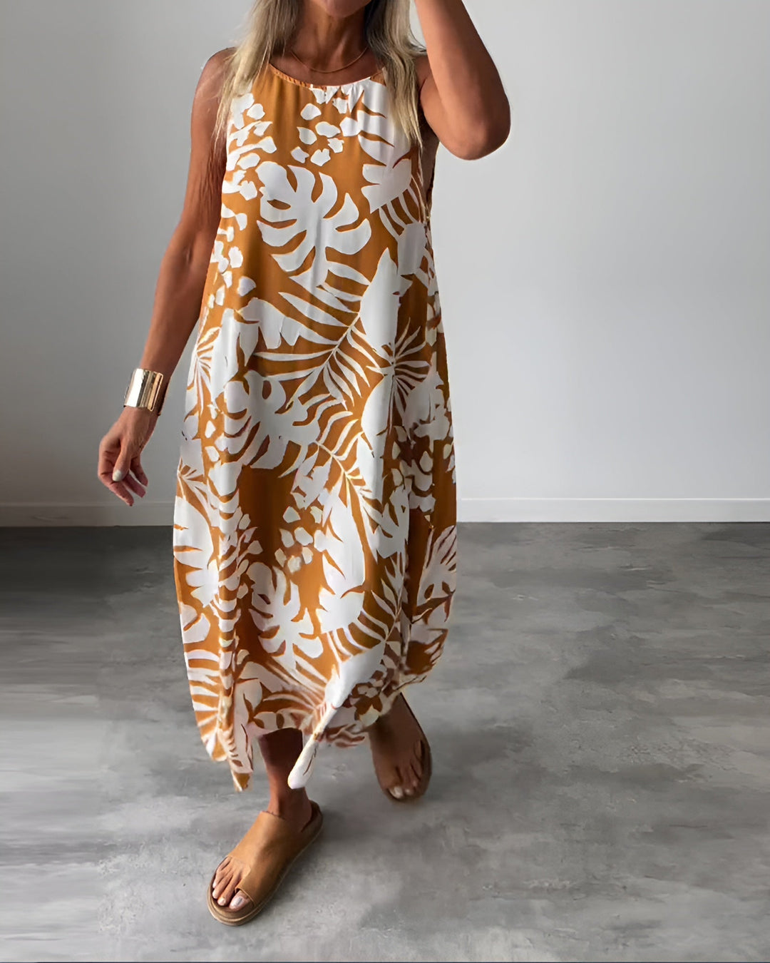Woman wearing the Felicity sleeveless draped evening dress in green, full-length front view