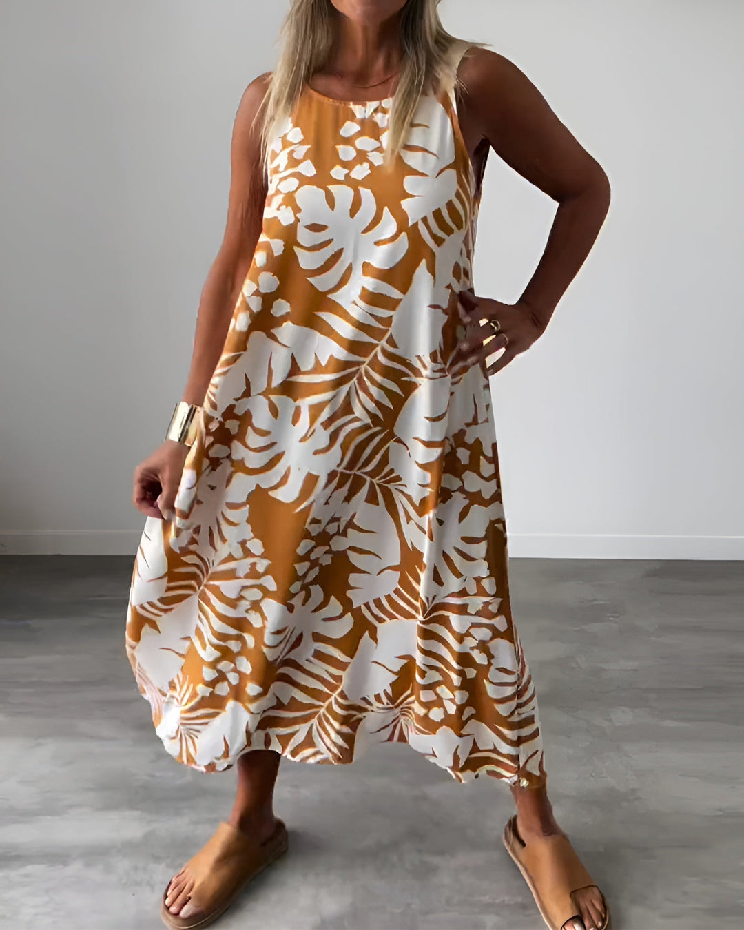 Woman wearing the Felicity sleeveless draped evening dress in blue, full-length front view
