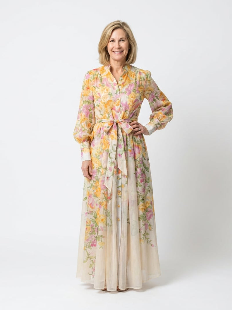 Woman wearing the Felicity yellow floral long sleeve maxi dress with button front detail, full length front view