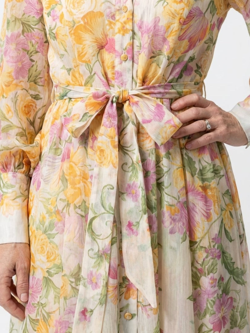 Side view of the Felicity yellow floral maxi dress showing floor-length silhouette and long sleeves