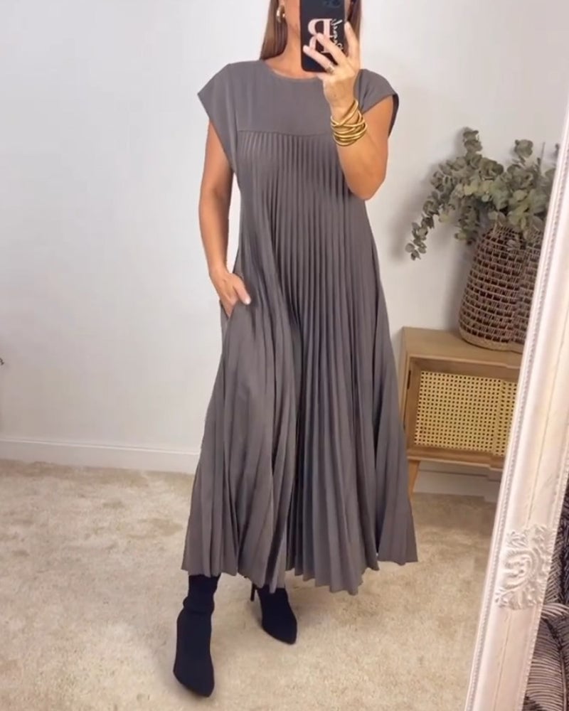 Close-up of the pleated fabric and drape on the Fern maxi dress in grey