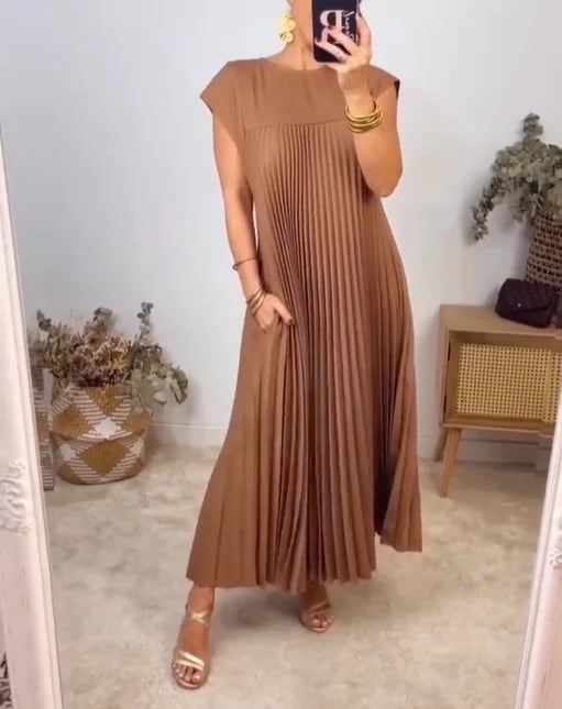 Woman in the Fern maxi dress in brown, highlighting the defined waistline and flowing skirt