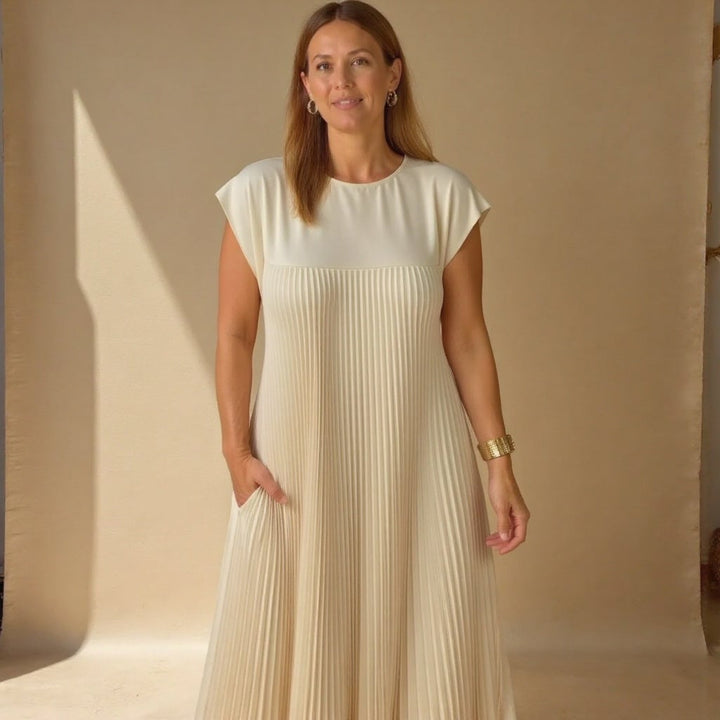 Woman smiling in the Fern flowy maxi dress in grey, styled for a cocktail occasion