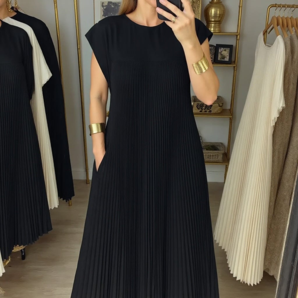 Close-up of the neckline on the Fern flowy pleated maxi dress in beige