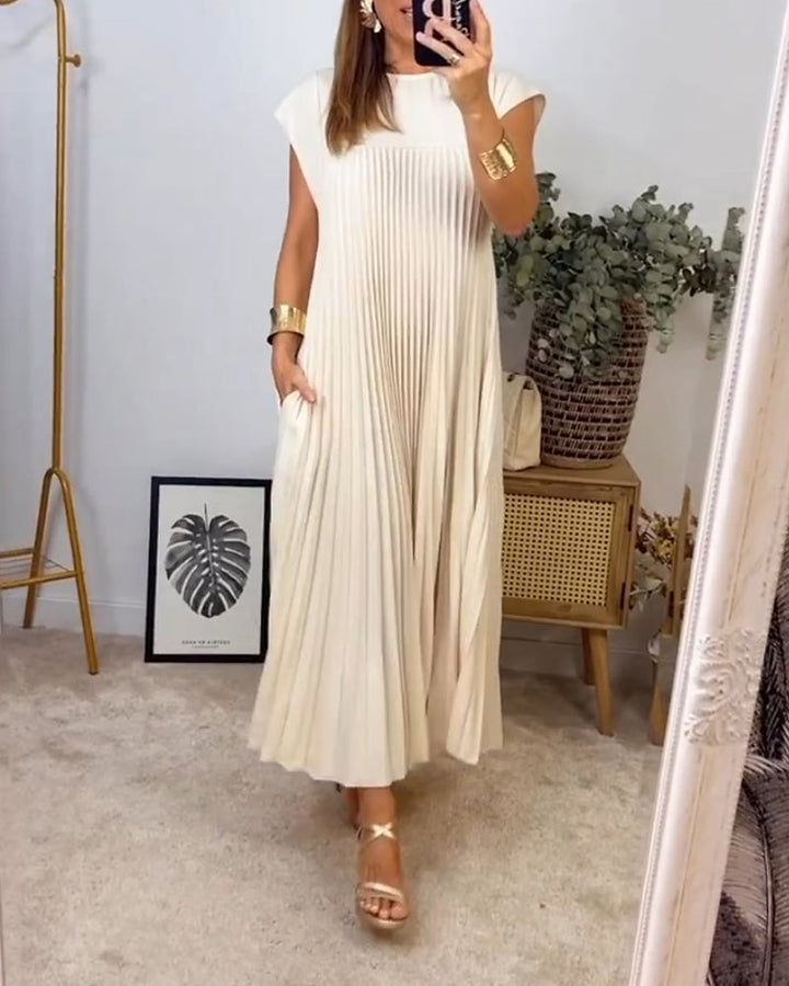 Model wearing the Fern maxi dress in brown at a garden event setting