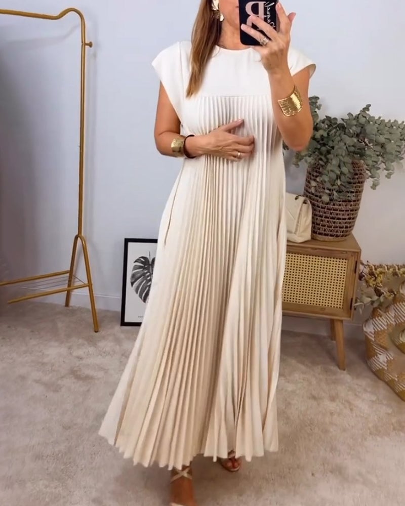 Fern pleated maxi dress in beige showing the hem and floor-length cut
