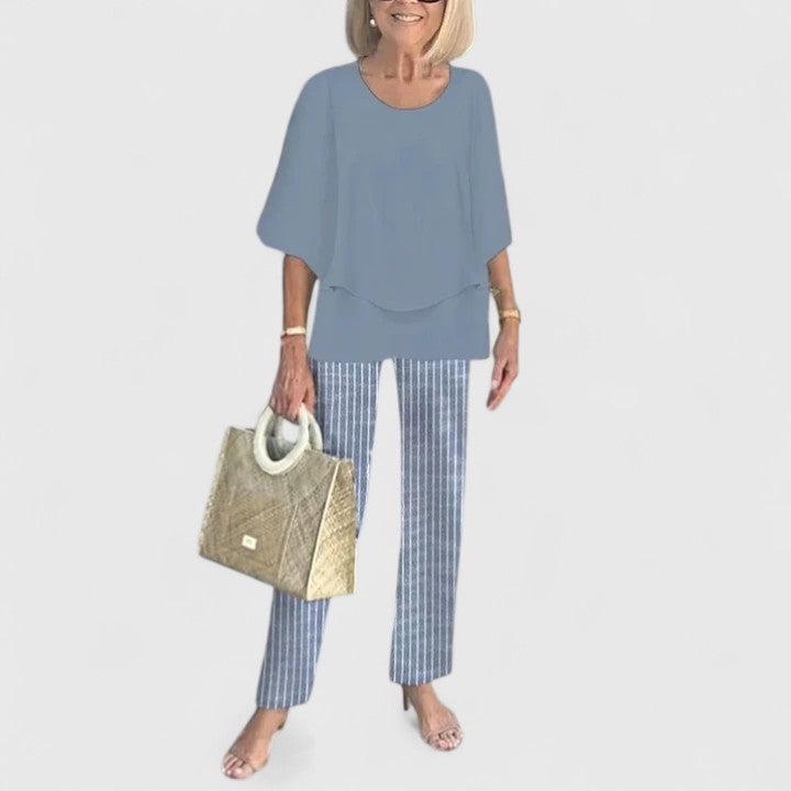 Close-up of the botanical leaf-and-branch print on the wide-leg pants in light gray