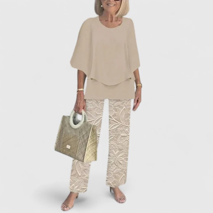 Model wearing the Fern set in blue with the batwing top draped over wide-leg pants