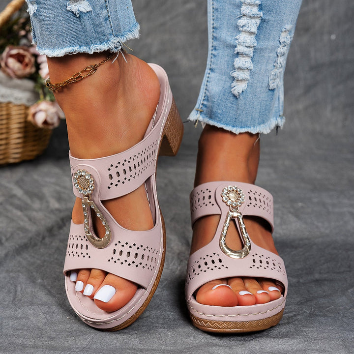 Finley blue flat sandals styled with white wide-leg trousers