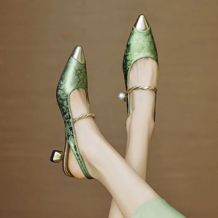Side view of Fleur pointed toe slingback pumps showing twisted pearl ankle strap detail