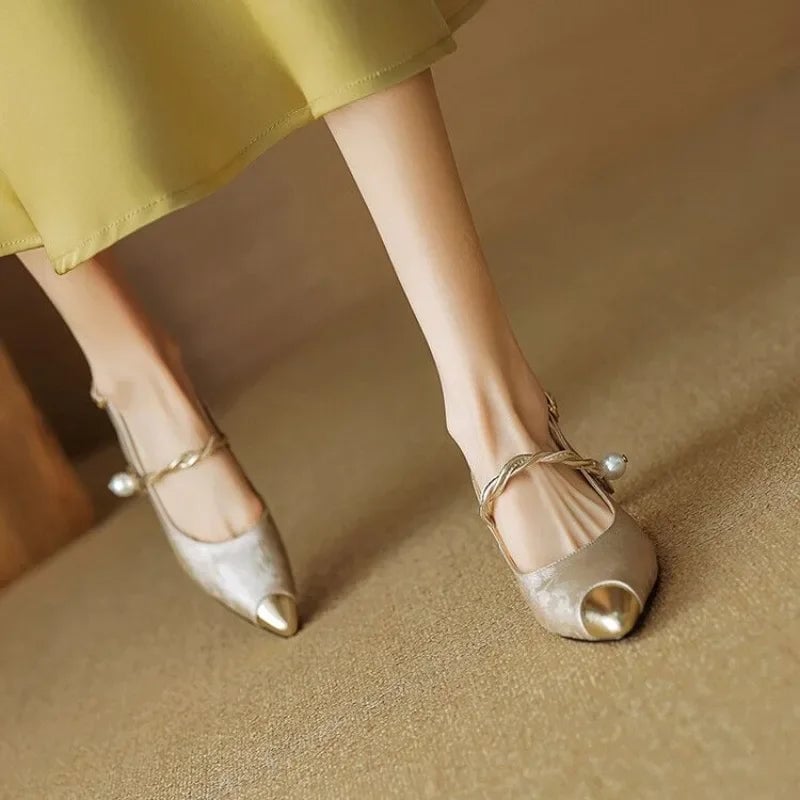 Back view of Fleur slingback pumps highlighting sculpted gold-tone kitten heel