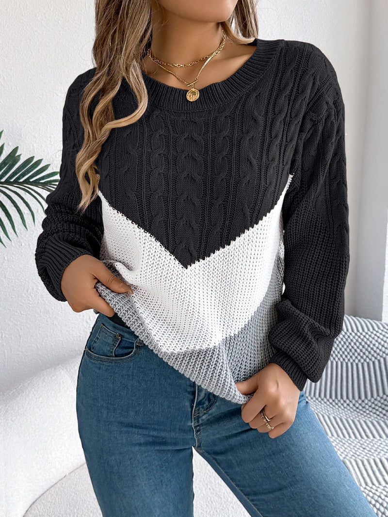 Woman wearing a chevron stitch pullover sweater with ribbed cuffs and hem in a classic knit pattern
