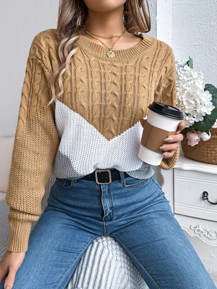 Side profile of model in a chevron knit pullover showing relaxed fit and ribbed hem
