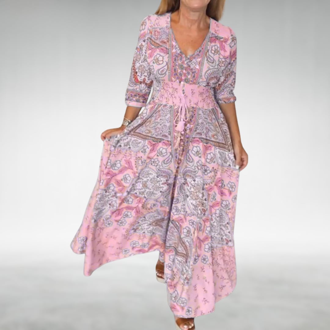 Side profile of the Flora flowy maxi dress in pink showing the elongating silhouette and graceful hem