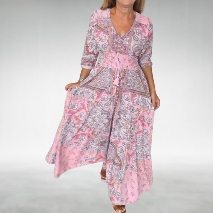 Side profile of the Flora flowy maxi dress in pink showing the elongating silhouette and graceful hem