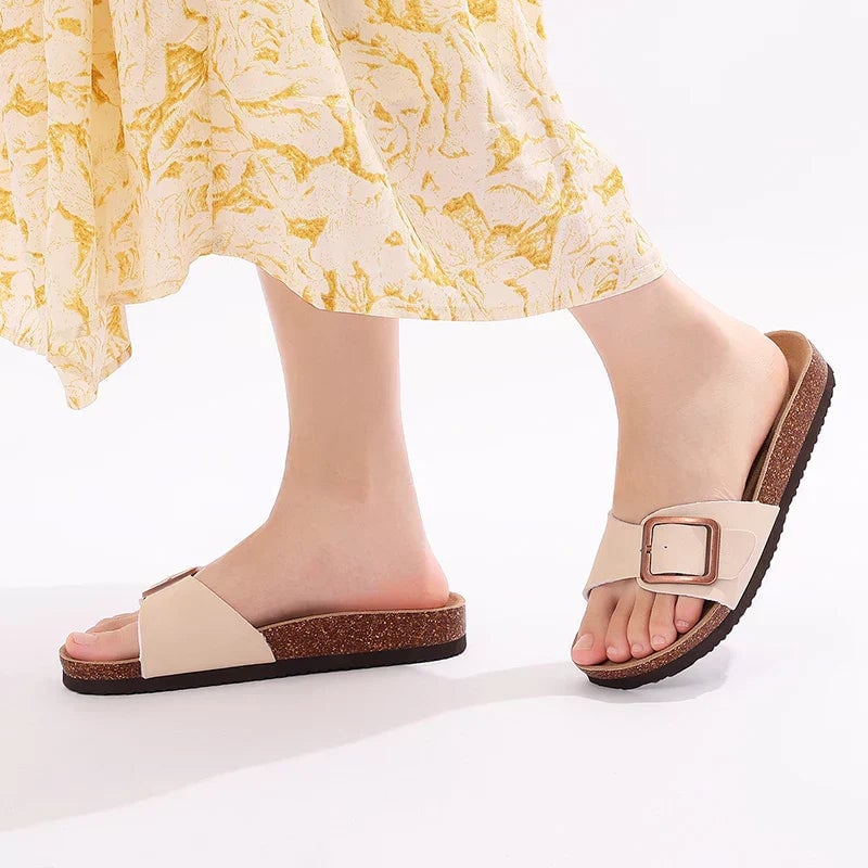 Flora flat adjustable buckle sandals in pink on a clean white background, front view