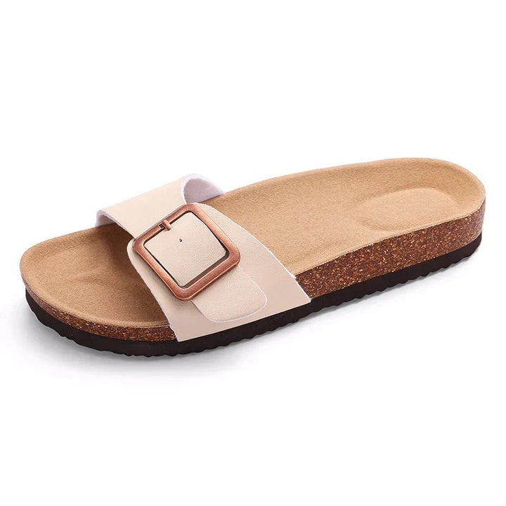 Flora flat buckle sandals in black, side profile showing cushioned insole and strap detail