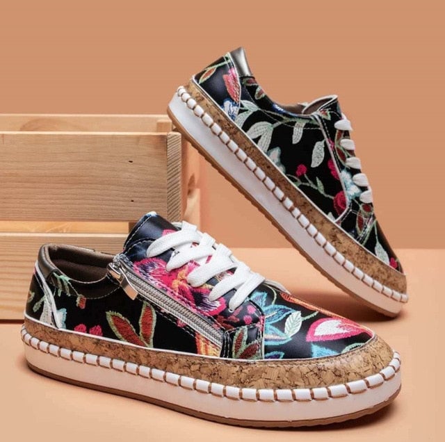 Side profile of Flora women's sneaker showing cork-style platform sole and zip closure