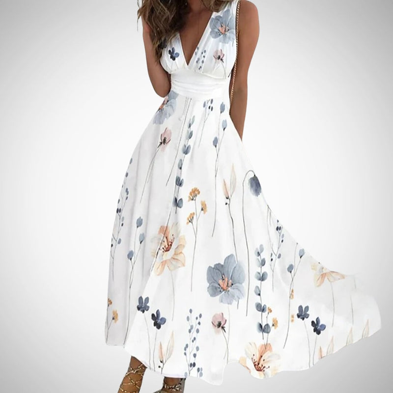 Model in the Flora floral maxi dress in floral white colorway styled with strappy sandals for a summer occasion