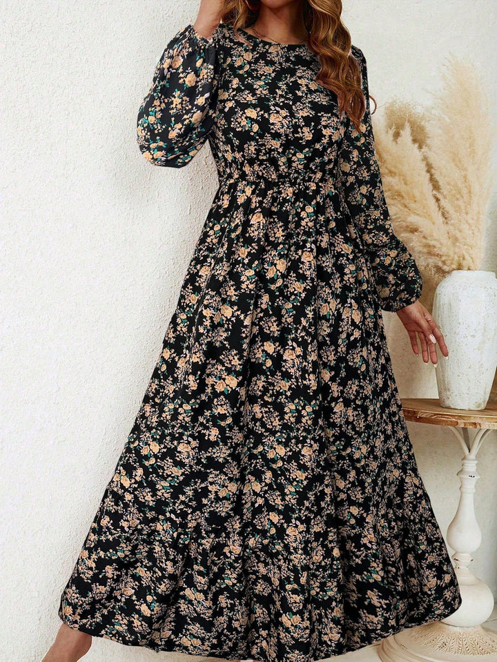 Woman wearing a black ditsy floral print bishop sleeve smocked waist maxi dress, full front view