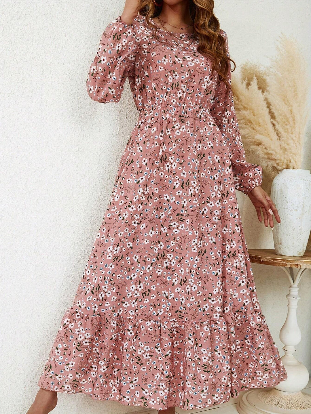 Side view of the Flora floral maxi dress showing the flowing A-line skirt and bishop sleeve silhouette