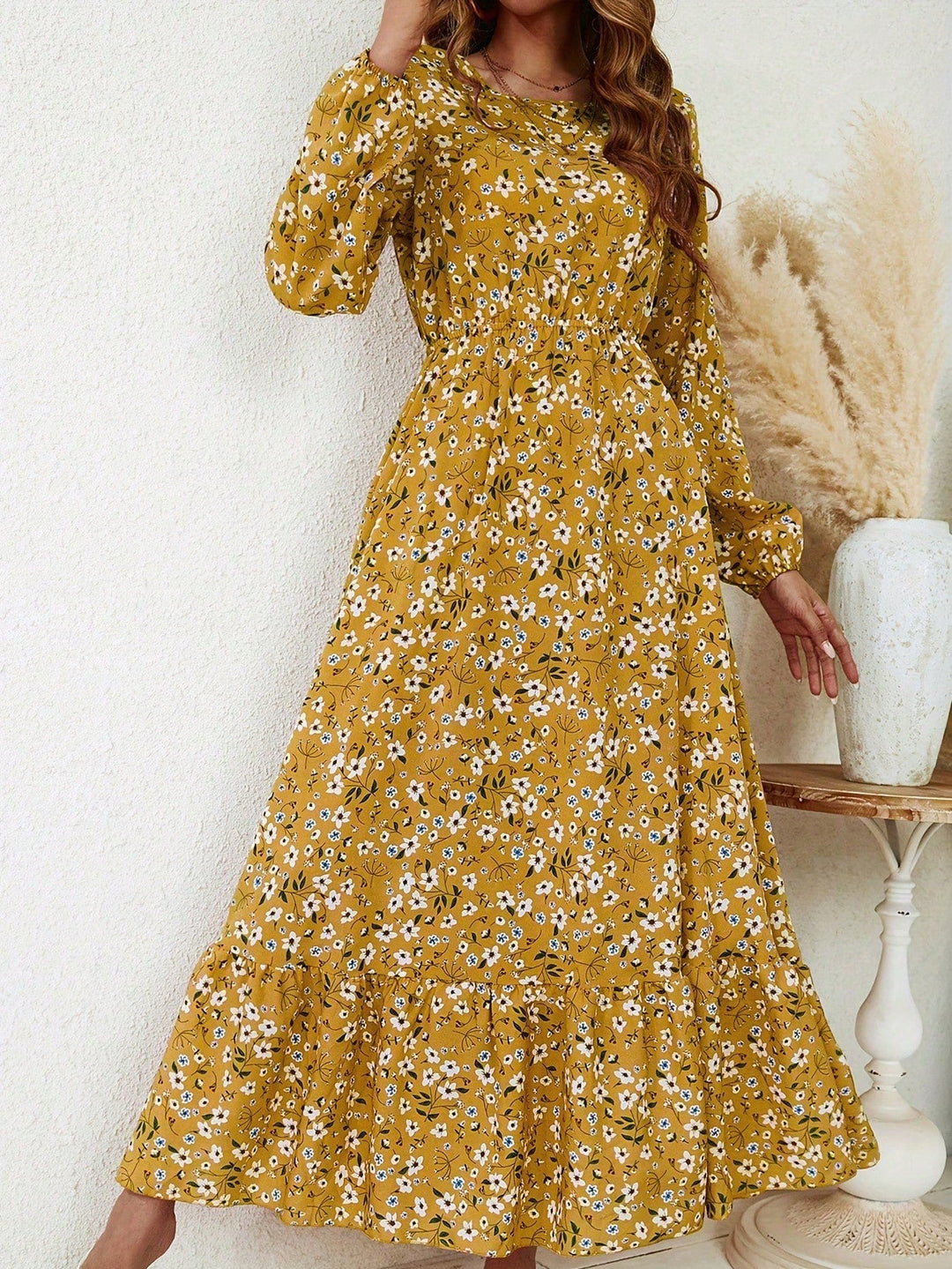 Woman in the Flora floral maxi dress styled with flat sandals for a casual daytime look
