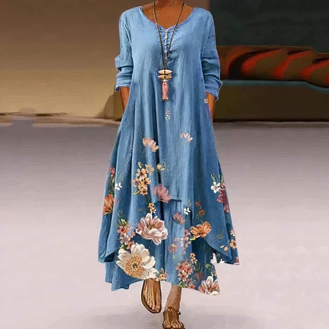 Back view of a floral long sleeve maxi dress in light gray showing flowing A-line shape