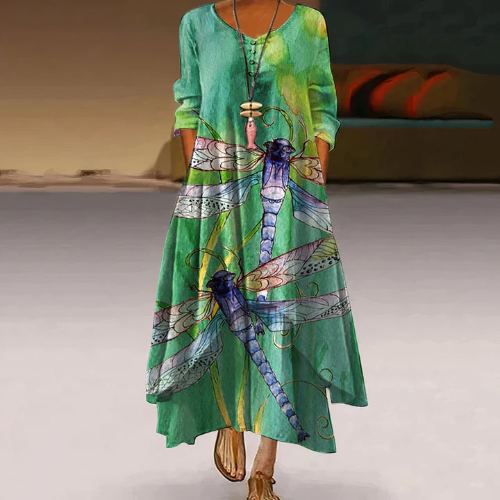 Woman in a green floral print long sleeve maxi dress, styled casually with sandals