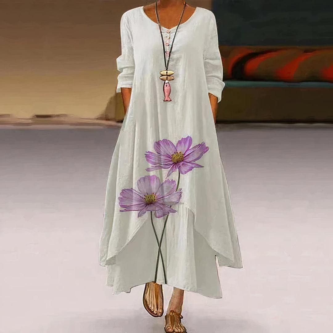 Flat lay of the Flora floral print long sleeve maxi dress showing full-length silhouette and print detail
