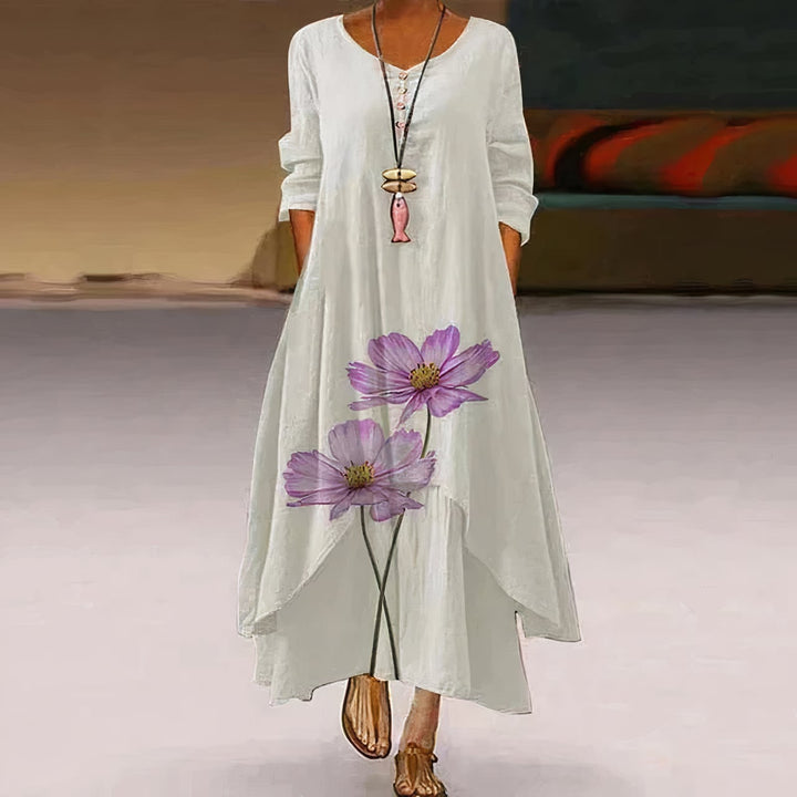 Flat lay of the Flora floral print long sleeve maxi dress showing full-length silhouette and print detail