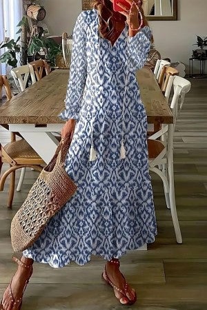 Full-length side view of a boho floral maxi dress showing the A-line silhouette and ruffled ankle hem