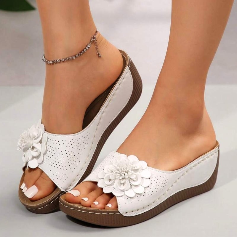 Flora flower wedge slide sandals in white with 3D floral appliqué and perforated upper, side view