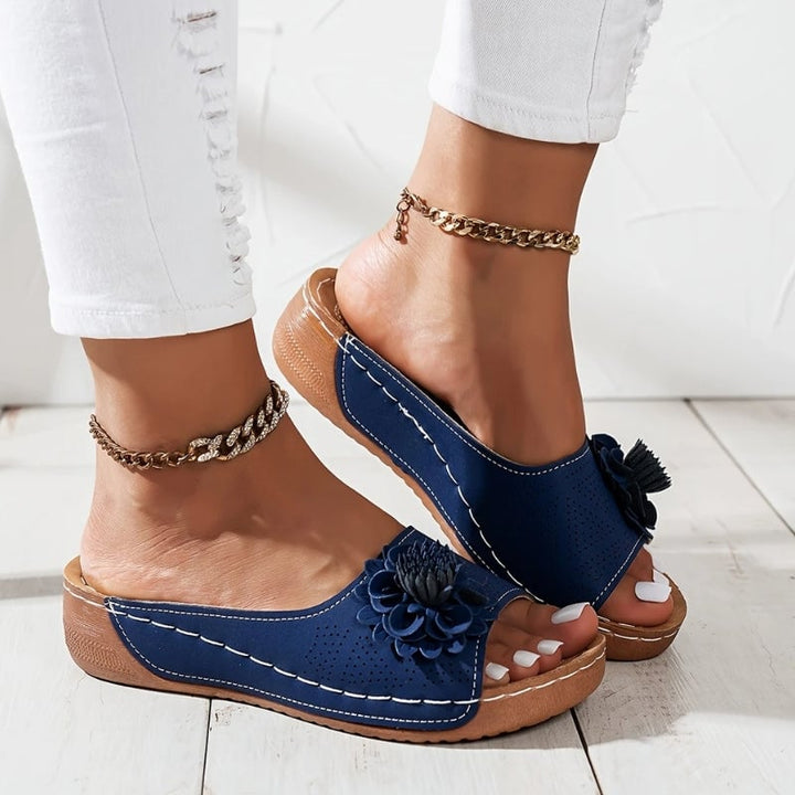 Flora slip-on wedge sandals in brown showing perforated upper and low wedge sole