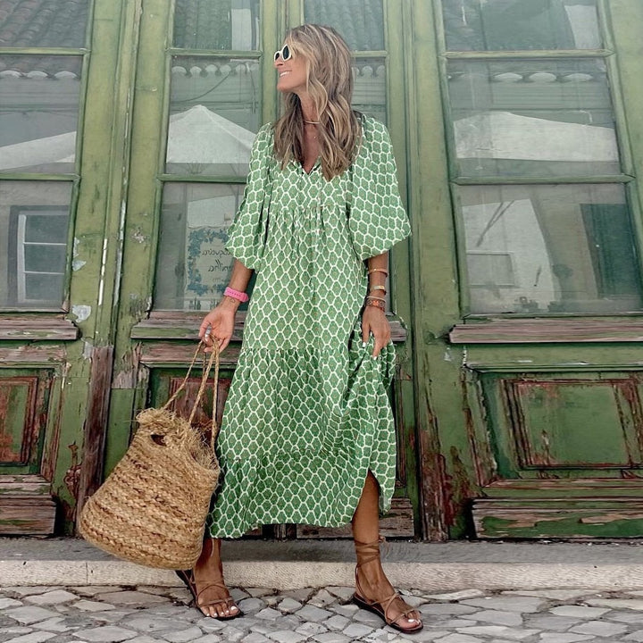 Woman wearing Flora boho maxi dress in purple with geometric print outdoors