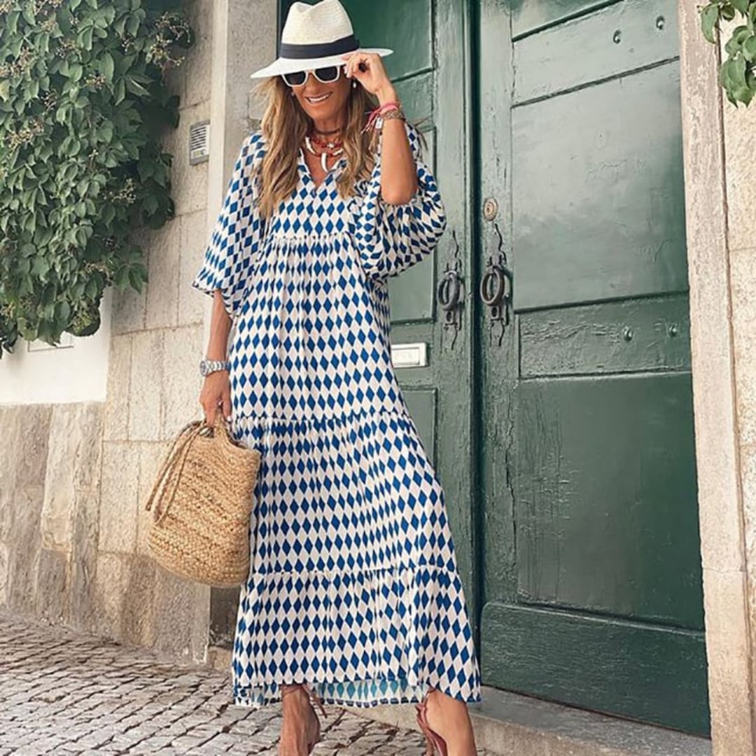 Woman wearing Flora boho maxi dress in blue with puff sleeves and V-neck