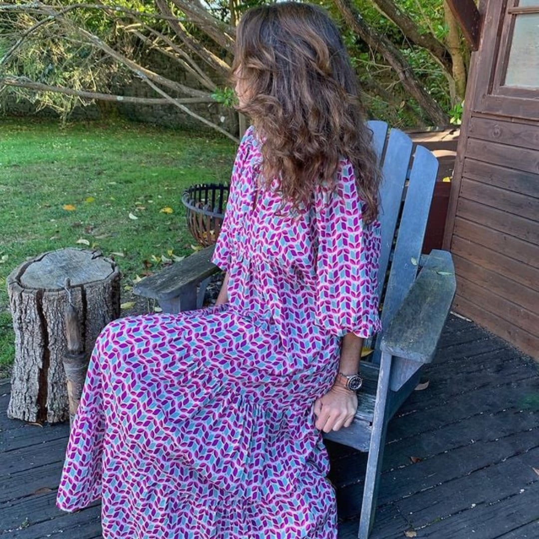 Model twirling in Flora boho maxi dress in purple to show fabric movement