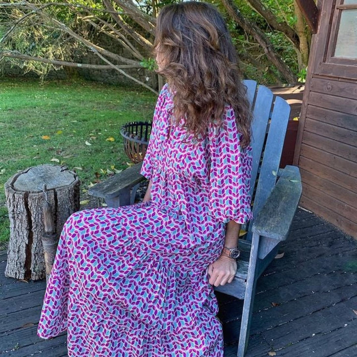 Model twirling in Flora boho maxi dress in purple to show fabric movement