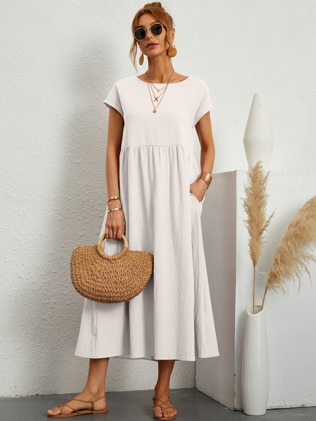 Florence dress shown in olive green colorway on a model