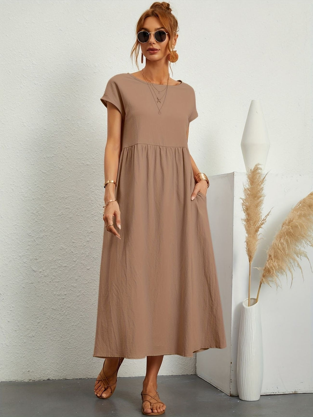 Florence dress shown in navy colorway on a standing model