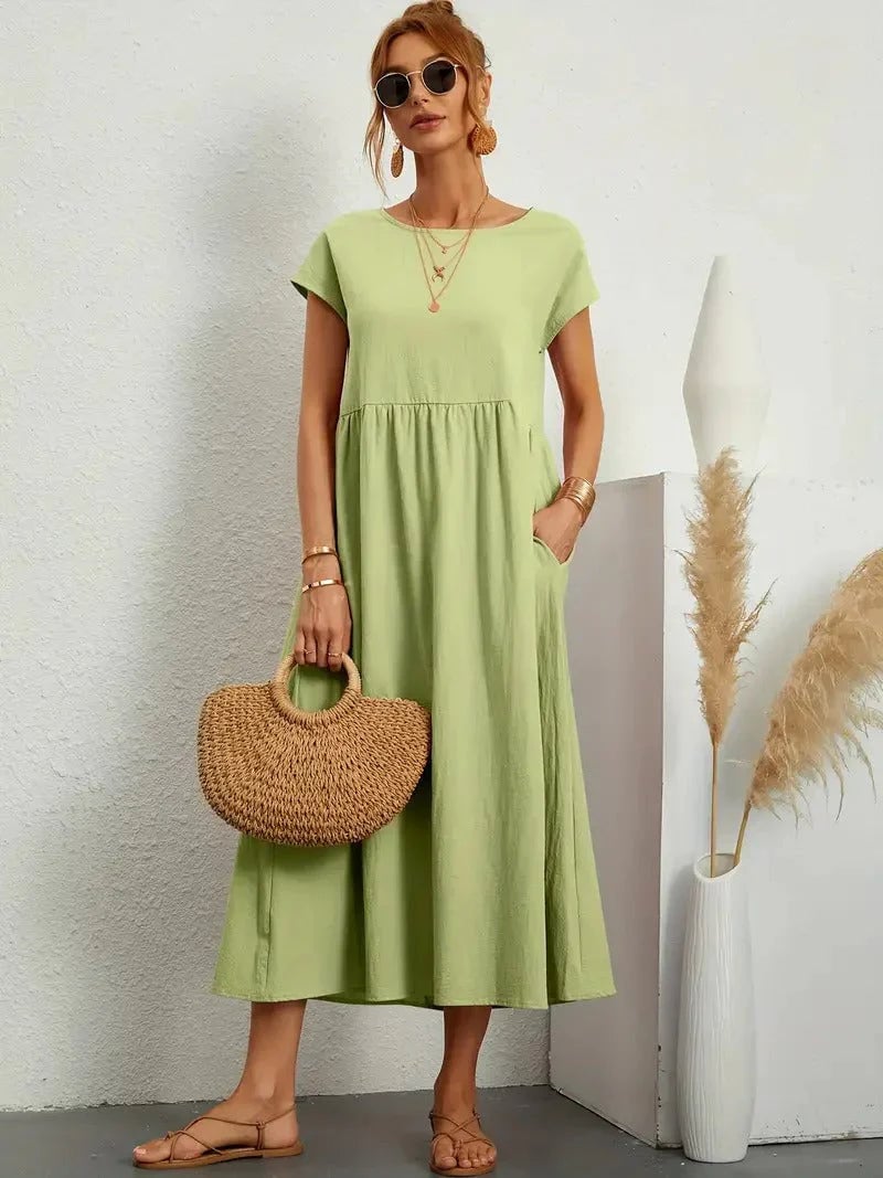 Florence dress shown in orange colorway on a model outdoors